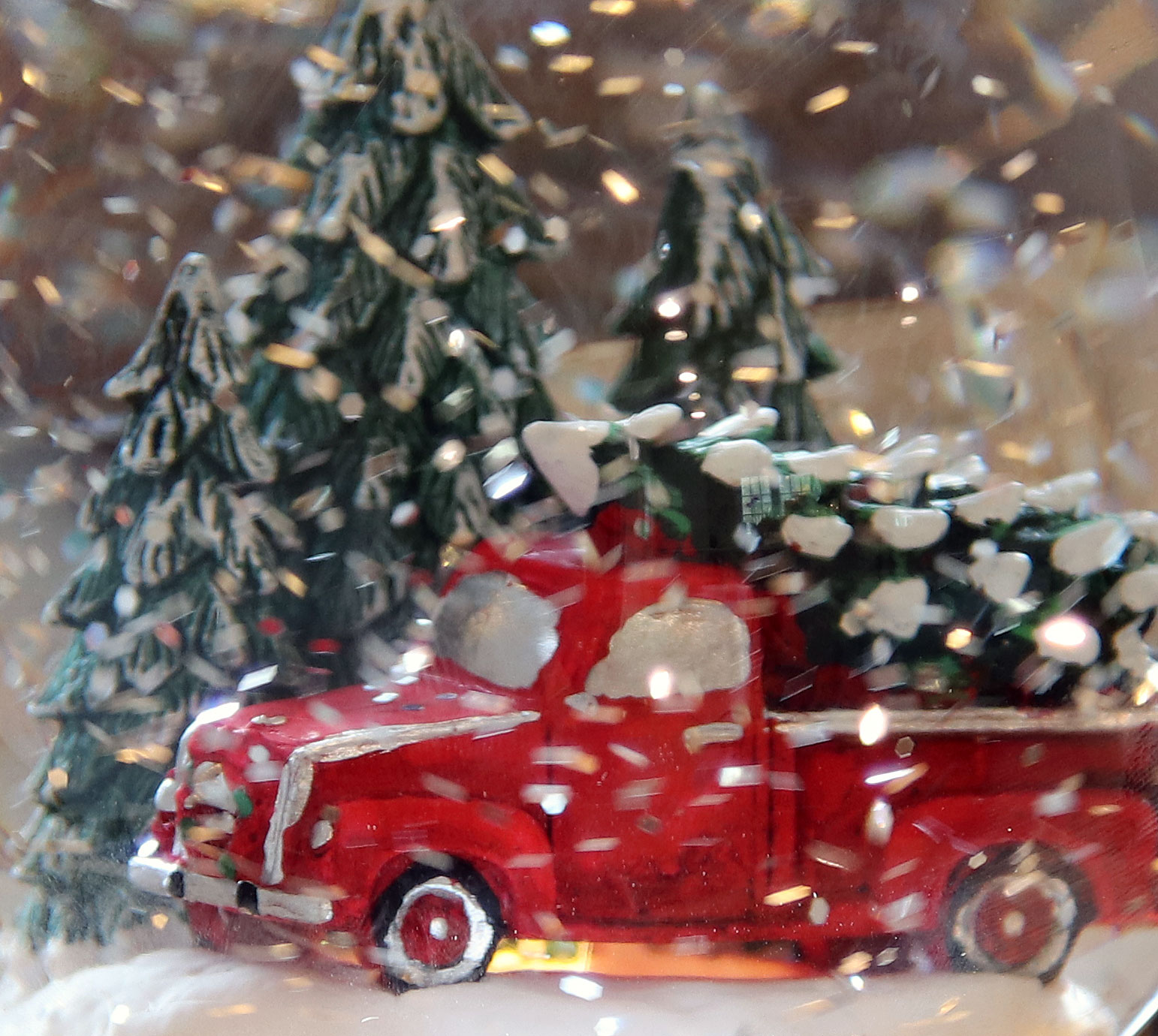 red truck with tree lighted snow globe with swirling mesh net lights